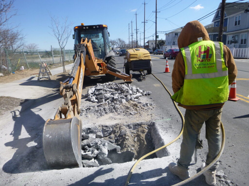 technician-performing-water-main-repair-in-bronx-ny