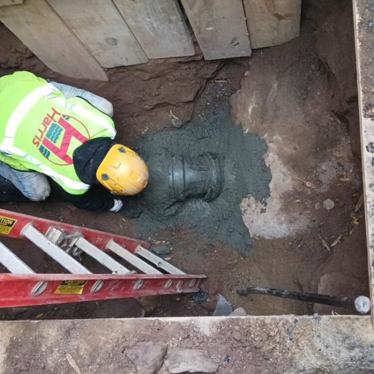 Sewer camera being inserted into a drain cleanout access point by Harris Water Main & Sewer Contractors Inc.